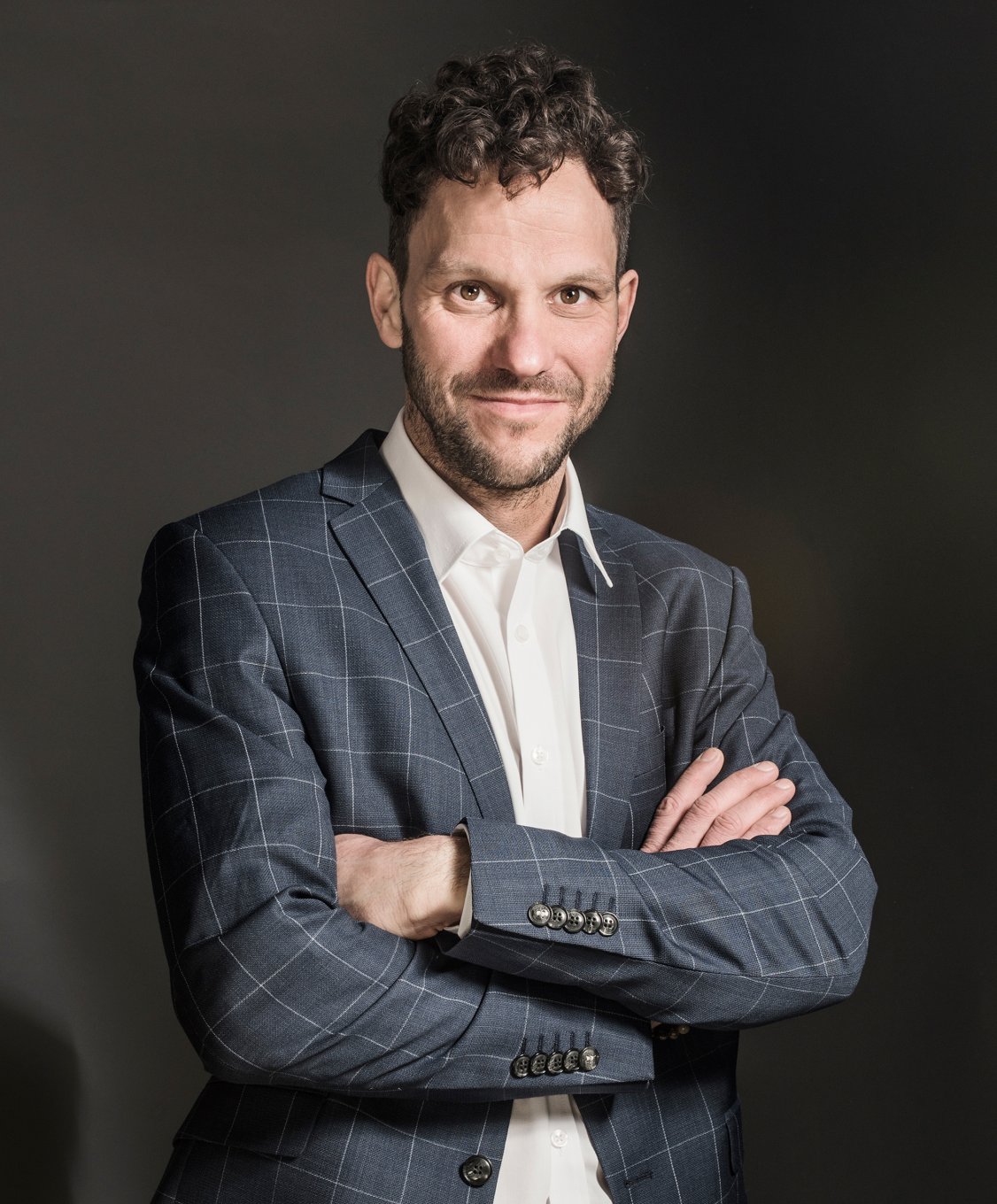 Porträt des Mannes Hannes Klingler, der lächelt und ein hellblaues Hemd trägt